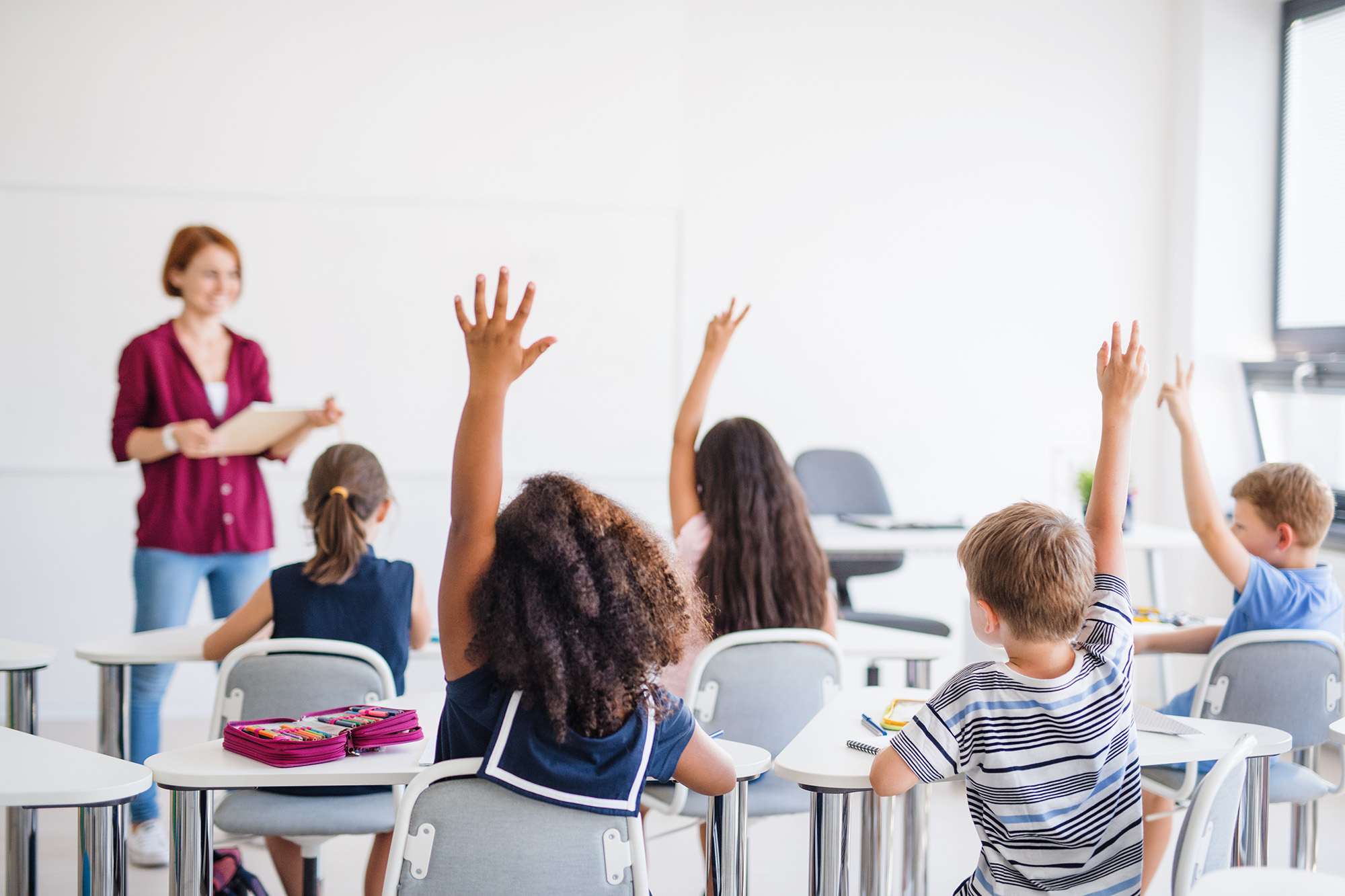 Students using eLearning technology in bright modern classroom